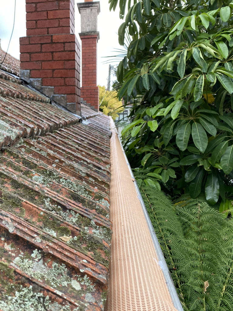 Leaf Gutter Guard installed on an old tiled roof